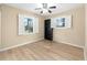 Bedroom featuring wood-look flooring, neutral paint, and two windows at 8 Banyan Dr, Ocala, FL 34472