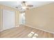 A bedroom featuring hardwood floors, a ceiling fan, and a closet with white doors at 8 Banyan Dr, Ocala, FL 34472