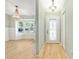 Inviting foyer view showing wood floors, chandelier and large bay window perfect for natural light at 8 Banyan Dr, Ocala, FL 34472