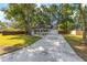 Charming single-story home with a long driveway, a one car garage, and a well-manicured front lawn at 8 Banyan Dr, Ocala, FL 34472