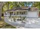 Charming single-story home featuring a well-manicured yard and attached garage, perfect for suburban living at 8 Banyan Dr, Ocala, FL 34472