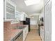 Eat-in kitchen with stainless steel sink, matching appliances, and view to dining room at 8 Banyan Dr, Ocala, FL 34472