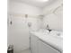 Bright laundry room with washer, dryer, and white wire shelving at 8 Banyan Dr, Ocala, FL 34472
