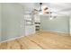 Open living area boasts vaulted ceilings, a fireplace with TV above, and beautiful wood floors throughout at 8 Banyan Dr, Ocala, FL 34472