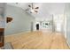 Open-concept living area with wood floors, vaulted ceiling, and modern chandelier lighting near a dining space at 8 Banyan Dr, Ocala, FL 34472