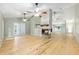 Expansive living room featuring wood floors, vaulted ceilings, fireplace, and seamless flow to other areas at 8 Banyan Dr, Ocala, FL 34472