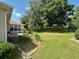 Expansive backyard with lush greenery, a privacy fence, and a serene patio area, perfect for outdoor enjoyment at 9019 Se 120Th Loop, Summerfield, FL 34491