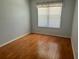 Clean empty bedroom with light colored walls, wood floors and window with blinds at 9019 Se 120Th Loop, Summerfield, FL 34491