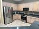 Well-equipped kitchen featuring stainless steel appliances, sleek countertops, and ample cabinet space at 9019 Se 120Th Loop, Summerfield, FL 34491
