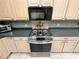 Updated kitchen with stainless steel gas range and stylish tile backsplash at 9019 Se 120Th Loop, Summerfield, FL 34491