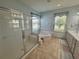 Elegant bathroom with a glass shower, soaking tub, and dual sink vanity at 9019 Se 120Th Loop, Summerfield, FL 34491