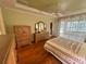 Sunlit main bedroom boasts wood floors and access to a sunroom, creating a serene retreat at 9019 Se 120Th Loop, Summerfield, FL 34491