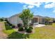 The back of the house features a screened-in lanai and a well-manicured lawn at 9923 Sw 98Th Ln, Ocala, FL 34481