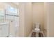 Bathroom with shower featuring safety bar, handheld sprayer, and toilet at 9923 Sw 98Th Ln, Ocala, FL 34481