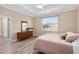 Light filled bedroom with a view from the window, wood-look floors, and neutral walls at 9923 Sw 98Th Ln, Ocala, FL 34481
