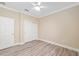 Bright bedroom with laminate floors, ceiling fan, neutral walls, and closet at 9923 Sw 98Th Ln, Ocala, FL 34481