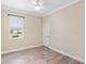 Bright bedroom with laminate floors, ceiling fan, neutral walls, and large window at 9923 Sw 98Th Ln, Ocala, FL 34481