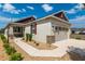 Charming home featuring stone accents, desert landscaping, and attached two car garage at 9923 Sw 98Th Ln, Ocala, FL 34481