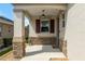 Welcoming covered front porch with stylish stone accents and decor at 9923 Sw 98Th Ln, Ocala, FL 34481