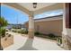 Spacious front porch showcasing stone-clad columns, landscaped surroundings, and a view of the neighborhood at 9923 Sw 98Th Ln, Ocala, FL 34481