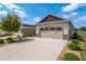 Two car garage with desert landscaping and a long driveway at 9923 Sw 98Th Ln, Ocala, FL 34481