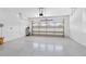 Spacious two-car garage with epoxy flooring and an insulated garage door with windows at 9923 Sw 98Th Ln, Ocala, FL 34481