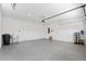 Spacious two-car garage with epoxy flooring, storage, and an insulated garage door at 9923 Sw 98Th Ln, Ocala, FL 34481