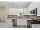 Stylish kitchen with granite countertops, tile backsplash, and stainless steel appliances at 9923 Sw 98Th Ln, Ocala, FL 34481