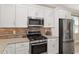 Beautiful kitchen with stainless steel appliances, granite countertops, and a stylish backsplash at 9923 Sw 98Th Ln, Ocala, FL 34481