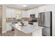 Modern kitchen featuring granite countertops, stainless steel appliances, and white cabinetry at 9923 Sw 98Th Ln, Ocala, FL 34481