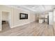 Spacious living room featuring a tray ceiling, hardwood floors, and ample natural light at 9923 Sw 98Th Ln, Ocala, FL 34481
