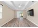Bright living room features wood-look floors and a sliding glass door that leads to an outdoor space at 9923 Sw 98Th Ln, Ocala, FL 34481