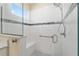 Tiled shower with glass, seat, handheld sprayer, and built in safety bar at 9923 Sw 98Th Ln, Ocala, FL 34481