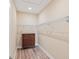 Spacious walk-in closet with wooden dresser, laminate floors, and ample white shelving at 9923 Sw 98Th Ln, Ocala, FL 34481