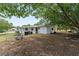 Spacious backyard featuring lush trees, storage, and a fenced perimeter for privacy at 9940 Sw 103Rd Pl, Ocala, FL 34481