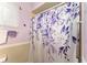 This is a vibrant bathroom showcasing a floral-patterned shower curtain at 9940 Sw 103Rd Pl, Ocala, FL 34481