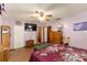 Spacious bedroom featuring wood floors, lavender walls, and custom wood storage cabinets at 9940 Sw 103Rd Pl, Ocala, FL 34481