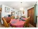Bright dining area with a table set for mealtime and a view into the kitchen at 9940 Sw 103Rd Pl, Ocala, FL 34481