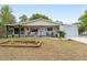 Charming single-story home with a covered front porch, manicured lawn, and attached garage at 9940 Sw 103Rd Pl, Ocala, FL 34481