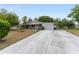 This is an inviting single-Gathering home with a long driveway and lush landscaping at 9940 Sw 103Rd Pl, Ocala, FL 34481