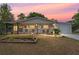 Charming single-story home at sunset with a covered front porch and attached garage at 9940 Sw 103Rd Pl, Ocala, FL 34481