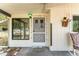 This is an inviting porch, featuring a cozy chair and floral decor at 9940 Sw 103Rd Pl, Ocala, FL 34481
