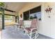 Inviting front porch with comfortable rocking chairs and decorative hangings at 9940 Sw 103Rd Pl, Ocala, FL 34481