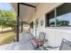 View of the covered porch with comfortable chairs and decorative hangings at 9940 Sw 103Rd Pl, Ocala, FL 34481