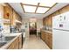 Kitchen featuring wooden cabinets, tile flooring, and view into the dining area at 9940 Sw 103Rd Pl, Ocala, FL 34481