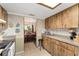 Practical kitchen with wooden cabinets, tile flooring, and view into the dining area at 9940 Sw 103Rd Pl, Ocala, FL 34481
