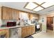 Traditional kitchen featuring wood cabinets, stainless steel appliances, and neutral countertops at 9940 Sw 103Rd Pl, Ocala, FL 34481