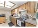 Well-lit kitchen featuring modern appliances, wooden cabinets, and ample counter space at 9940 Sw 103Rd Pl, Ocala, FL 34481
