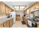 Functional kitchen with wood cabinets, tiled floors, and modern appliances at 9940 Sw 103Rd Pl, Ocala, FL 34481