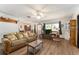 Bright living room featuring wood floors, a ceiling fan, and large windows with a view at 9940 Sw 103Rd Pl, Ocala, FL 34481